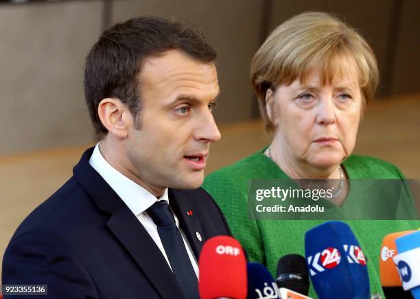 German Prime Minister Angela Merkel and French President Emmanuel Macron answer the questions of press members as they arrive to attend the EU...