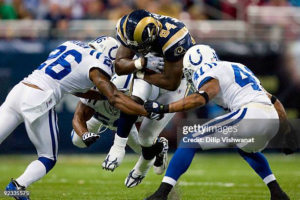 Randy McMichael of the St. Louis Rams is tackled by Kelvin Hayden and Antoine Bethea of the Indianapolis Colts at the Edward Jones Dome on October...