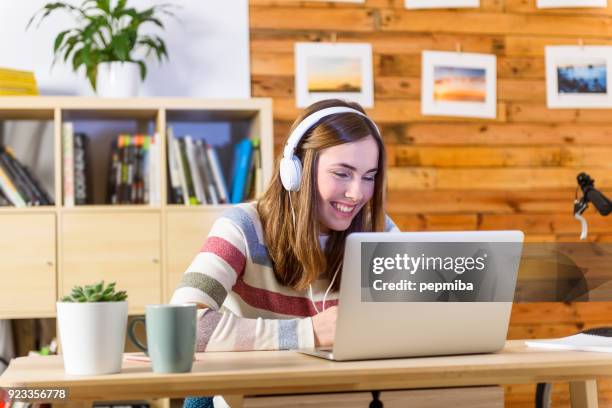 woman learning with headphones in laptop - office space movie stock pictures, royalty-free photos & images
