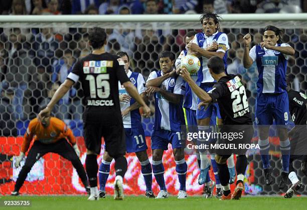 Academica's Emidio Rafael da Silva kicks the ball against FC Porto's line of defence during their Portuguese league football match against Academica...
