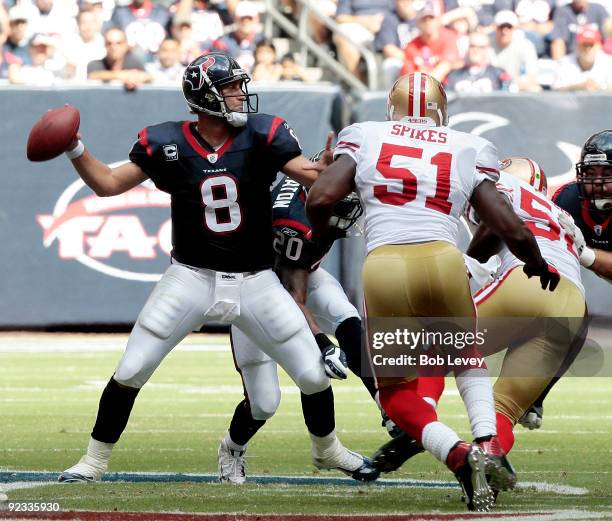 Quarterback Matt Schaub of the Houston Texans looks downfield for a receiver as linebacker Takeo Spikes of the San Francisco 49ers applies pressure...