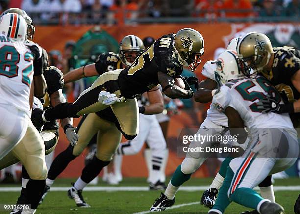 Wide receiver Courtney Roby of the New Orleans Saints goes airborne while returning a kick against the Miami Dolphins at Land Shark Stadium on...