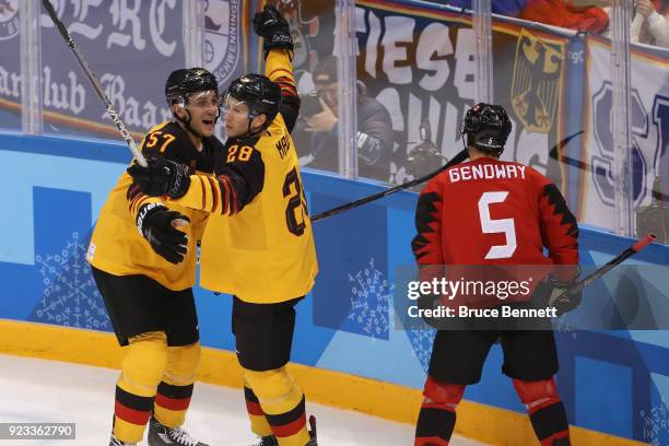 Marcel Goc and Frank Mauer of Germany celebrate after a goal by Mauer in the second period during the Men's Play-offs Semifinals on day fourteen of...