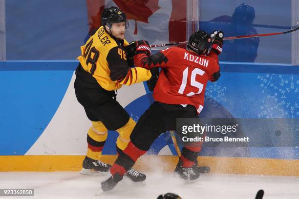 Brandon Kozun of Canada collides with Frank Hordler of Germany during the Men's Play-offs Semifinals on day fourteen of the PyeongChang 2018 Winter...