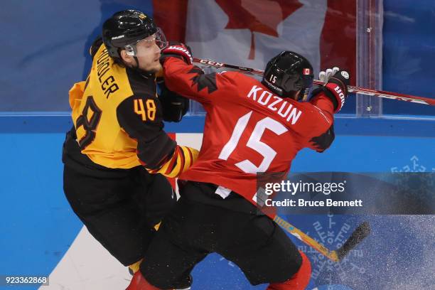 Brandon Kozun of Canada collides with Frank Hordler of Germany during the Men's Play-offs Semifinals on day fourteen of the PyeongChang 2018 Winter...