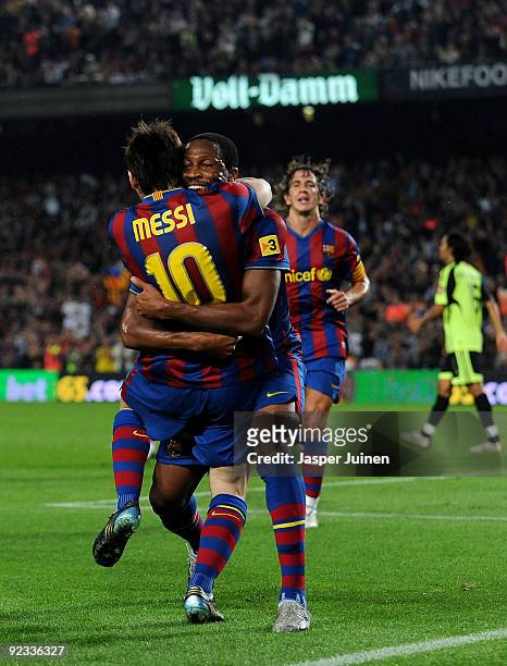 Seydou Keita of FC Barcelona celebrates scoring his sides opening goal with his teammate Lionel Messi during the La Liga match between FC Barcelona...