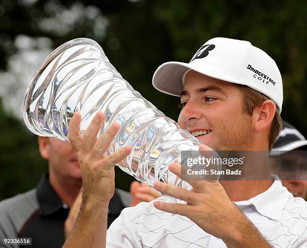 Matt Every is presented the winner's trophy on the 18th green during the final round of the Nationwide Tour Championship at Daniel Island Club on...