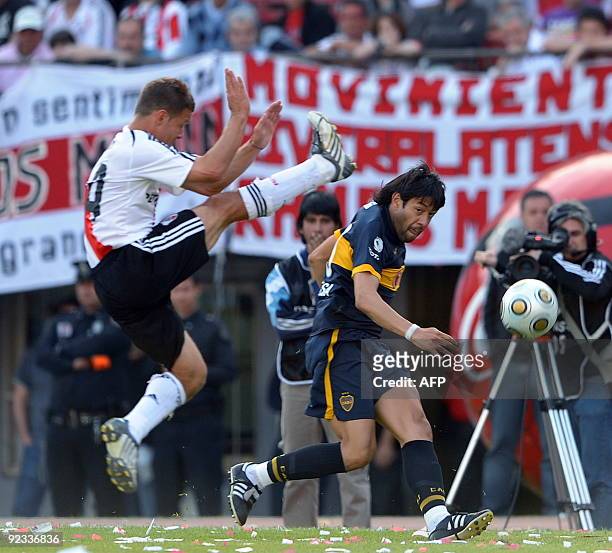River Plate's footballer Nicolas Domingo vies for the ball with Juan Krupoviesa of Boca Juniors during their Argentina's first division football...