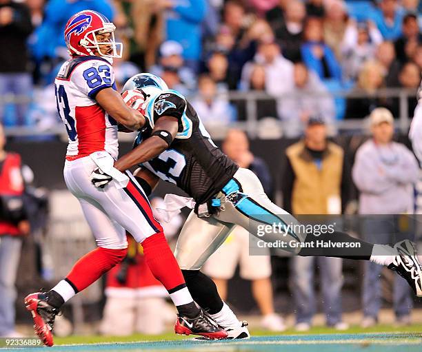 Lee Evans of the Buffalo Bills catches a touchdown as Chris Harris of the Carolina Panthers defends at Bank of America Stadium on October 25, 2009 in...