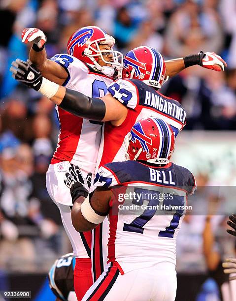 Lee Evans, Geoff Hangartner and Demetrius Bell of the Buffalo Bills celebrate Evans' touchdown against the Carolina Panthers at Bank of America...