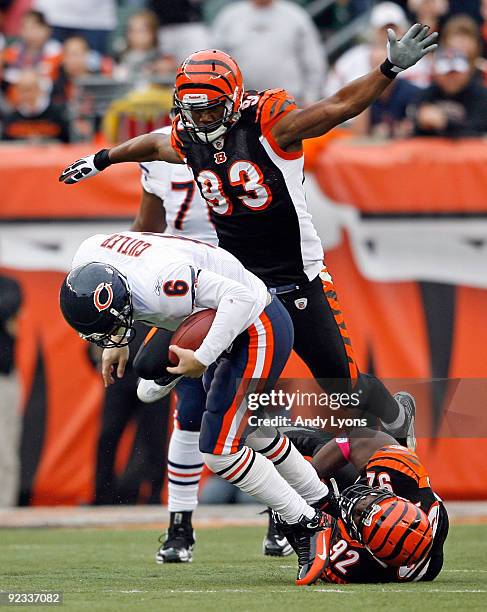 Jay Cutler of the Chicago Bears is sacked by Michael Johnson and Frostee Rucker of the Cincinnati Bengals at Paul Brown Stadium on October 25, 2009...