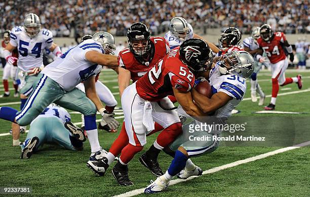 Kickoff return specialist Allen Rossum of the Dallas Cowboys is tackled by Coy Wire of the Atlanta Falcons at Cowboys Stadium on October 25, 2009 in...