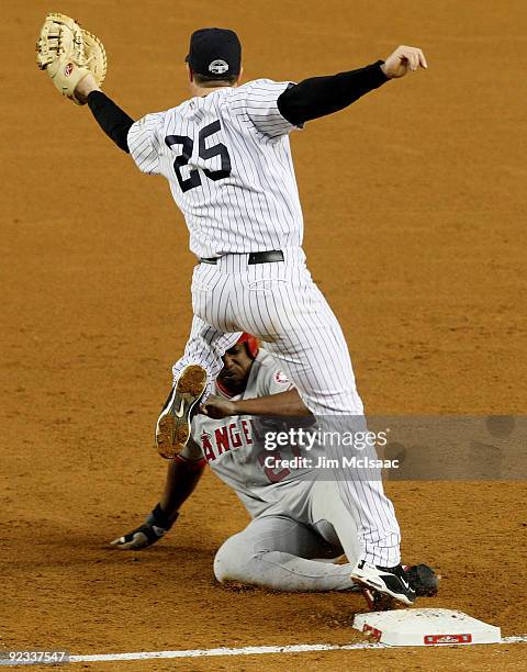 Vladimir Guerrero of the Los Angeles Angels of Anaheim is doubled off first base by Mark Teixeira of the New York Yankees on a throw from Nick...