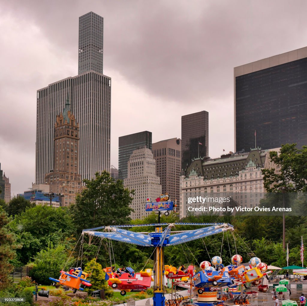 Manhattan skyline from the Victorian Gardens Amusement Park in Central Park, New York, USA