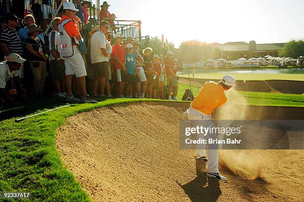 Rickie Fowler chips out of the bunker onto the 18th green to save par and make a playoff during the fourth round of the 2009 Frys.com Open on October...