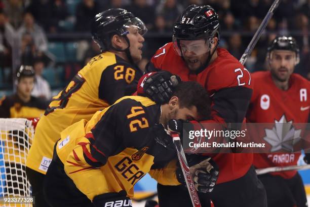 Cody Goloubef of Canada collides with Yasin Ehliz of Germany in the third period during the Men's Play-offs Semifinals on day fourteen of the...