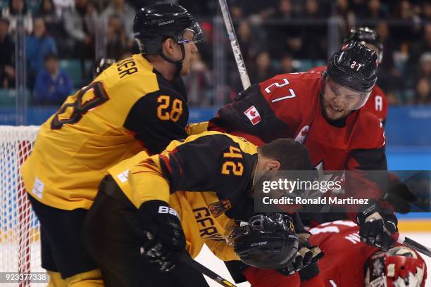 Cody Goloubef of Canada collides with Yasin Ehliz of Germany in the third period during the Men's Play-offs Semifinals on day fourteen of the...