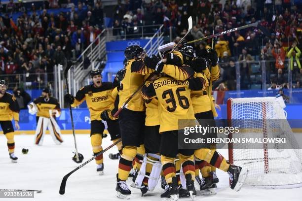 Germany's players celebrate winning the men's semi-final ice hockey match between Canada and Germany during the Pyeongchang 2018 Winter Olympic Games...