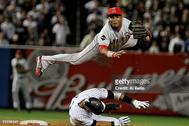 Alex Rodriguez of the New York Yankees is forced out at second base as Erick Aybar of the Los Angeles Angels of Anaheim throws to first base for a...
