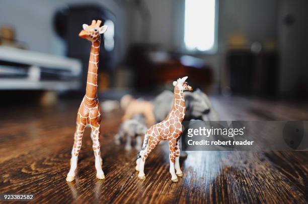 toy animals giraffes and elephant models on wooden floor - toy animal - fotografias e filmes do acervo