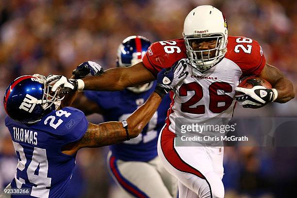 Beanie Wells of the Arizona Cardinals fends off Terrell Thomas of the New York Giants on October 25, 2009 at Giants Stadium in East Rutherford, New...