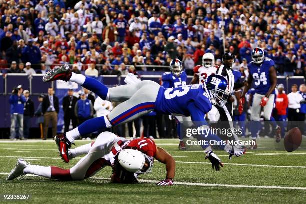 Corey Webster of the New York Giants deflects the ball away from Larry Fitzgerald of the Arizona Cardinals on October 25, 2009 at Giants Stadium in...
