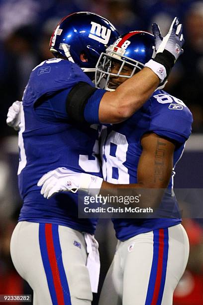 Hakeem Nicks of the New York Giants is congratulated by team mate Madison Hedgecock after scoring a touchdown against the Arizona Cardinals on...