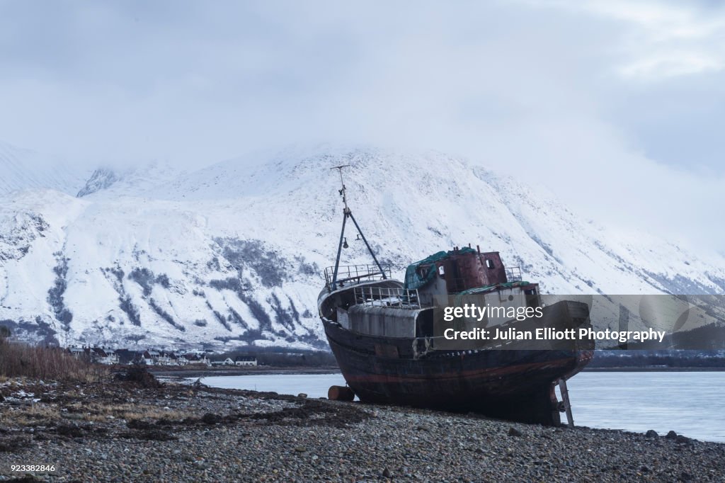 An old boat on Loch Linnhe with Ben Nevis in the background.