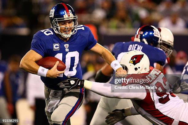 Eli Manning of the New York Giants is sacked by Calais Campbell of the Arizona Cardinals on October 25, 2009 at Giants Stadium in East Rutherford,...