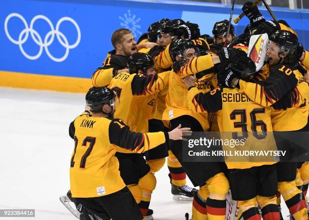 Germany's players celebrate winning the men's semi-final ice hockey match between Canada and Germany during the Pyeongchang 2018 Winter Olympic Games...