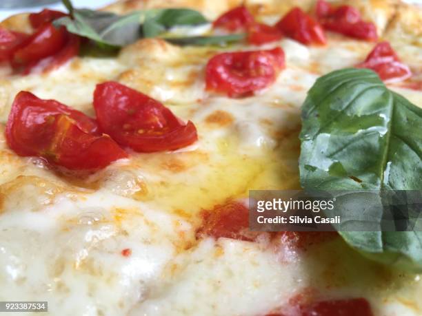 close-up pizza with cherry tomatoes - silvia casali stock-fotos und bilder