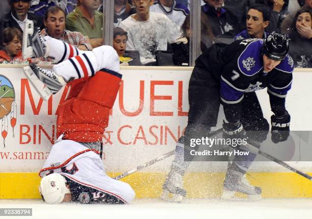 Rob Scuderi of the Los Angeles Kings knocks Jason Chimera of the Columbus Blue Jackets to the ice with a bodycheck during the first period at the...