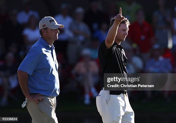Chris Stroud and Bill Lunde react after Jamie Lovemark made a birdie putt on the 18th green during the fourth round of the Frys.com Open at Grayhawk...