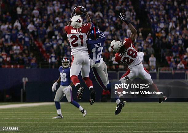 Antrel Rolle of the Arizona Cardinals intercepts a ball in front of Steve Smith of the New York Giants during the fourth quarter on October 25, 2009...