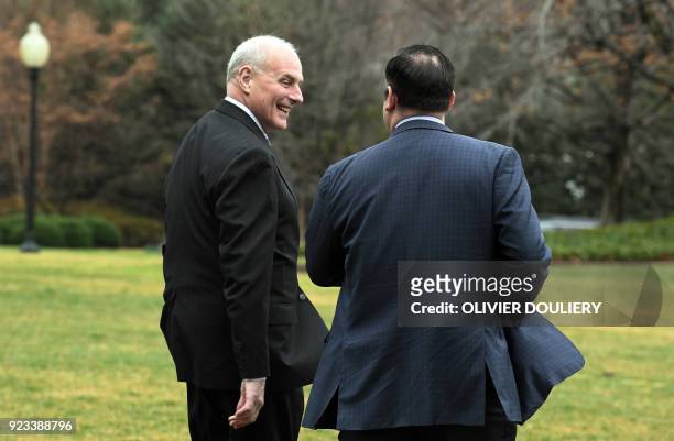 White House Chief of Staff John Kelly walks with an aide to Marine One as President Donald Trump departs the South Lawn of the White House in...