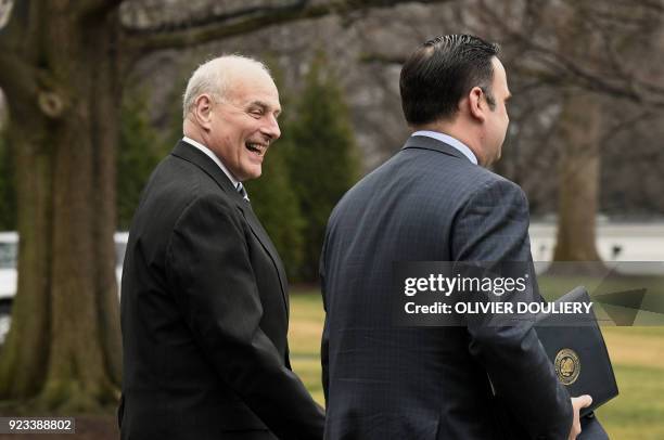 White House Chief of Staff John Kelly walks with an aide to Marine One as President Donald Trump departs the South Lawn of the White House in...
