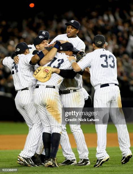 The New York Yankees celebrate their 5-2 victory over the Los Angeles Angels of Anaheim at the end of the top of the ninth inning in Game Six of the...