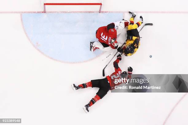 Kevin Poulin and Cody Goloubef of Canada defend against Dominik Kahun of Germany in the third period during the Men's Play-offs Semifinals on day...