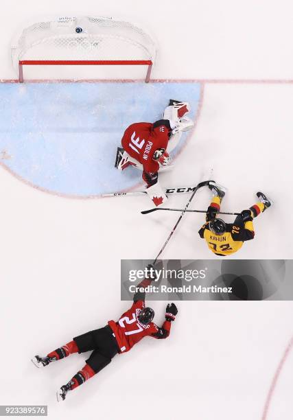 Kevin Poulin and Cody Goloubef of Canada defend against Dominik Kahun of Germany in the third period during the Men's Play-offs Semifinals on day...