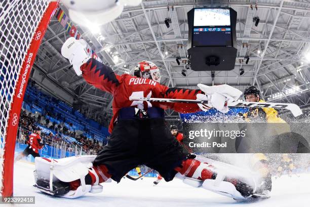 Kevin Poulin of Canada defends against Marcus Kink of Germany during the Men's Play-offs Semifinals on day fourteen of the PyeongChang 2018 Winter...