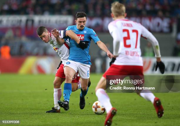 Diego Demme and Konrad Laimer of Leipzig vie with Mario Rui of Napoli during the UEFA Europa League Round of 32 match between RB Leipzig and Napoli...