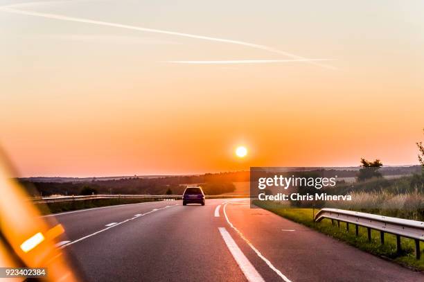 sun setting over a6 highway between nitry and auxerre - gold coast highway stock pictures, royalty-free photos & images