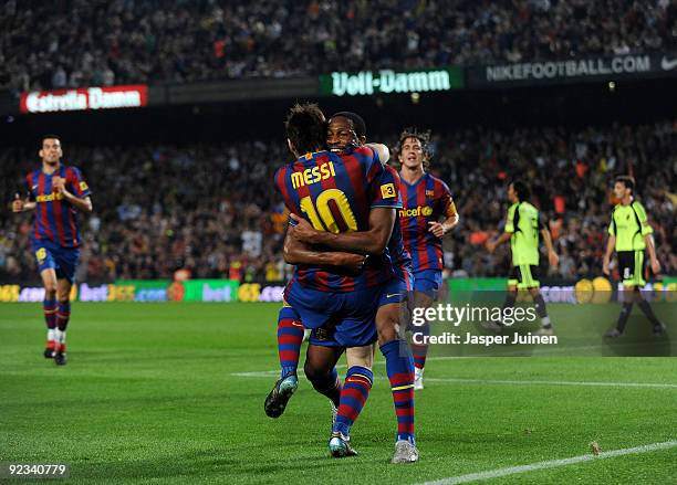 Seydou Keita of FC Barcelona celebrates scoring his sides opening goal with his teammate Lionel Messi during the La Liga match between FC Barcelona...