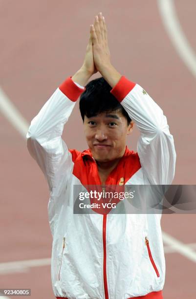 Olympic gold medalist Liu Xiang celebrates after the Men's 110m hurdles at the 11th Chinese National Games on October 25, 2009 in Jinan, east China's...