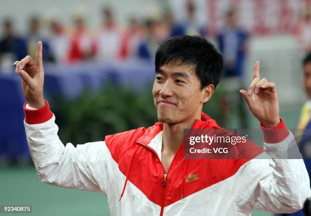 Olympic gold medalist Liu Xiang celebrates after the Men's 110m hurdles at the 11th Chinese National Games on October 25, 2009 in Jinan, east China's...