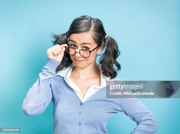 nerdy woman against blue background - nerdy latina stock pictures, royalty-free photos & images