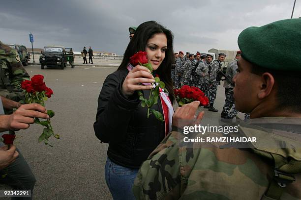 Lebanese pro-opposition protestor distributes roses on Lebanese troops guarding downtown Beirut during an anti-Syria rally 28 February 2005....