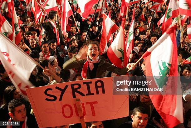 Young Lebanese demonstrators wave national flags and banners calling for Syrian army withdrawal from Lebanon 04 March 2005 during their open-ended...
