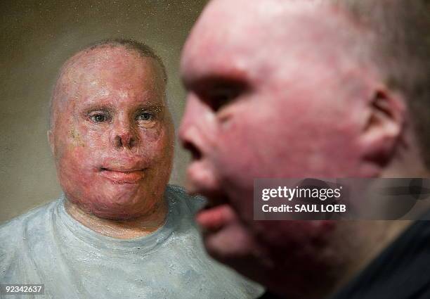 Rick Yarosh, a retired US Army Sergeant, stands next to an oil painting of himself by artist Matthew Mitchell of Amherst, Massachusetts, prior to the...