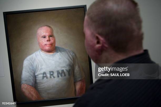 Rick Yarosh, a retired US Army Sergeant, stands next to an oil painting of himself by artist Matthew Mitchell of Amherst, Massachusetts, prior to the...